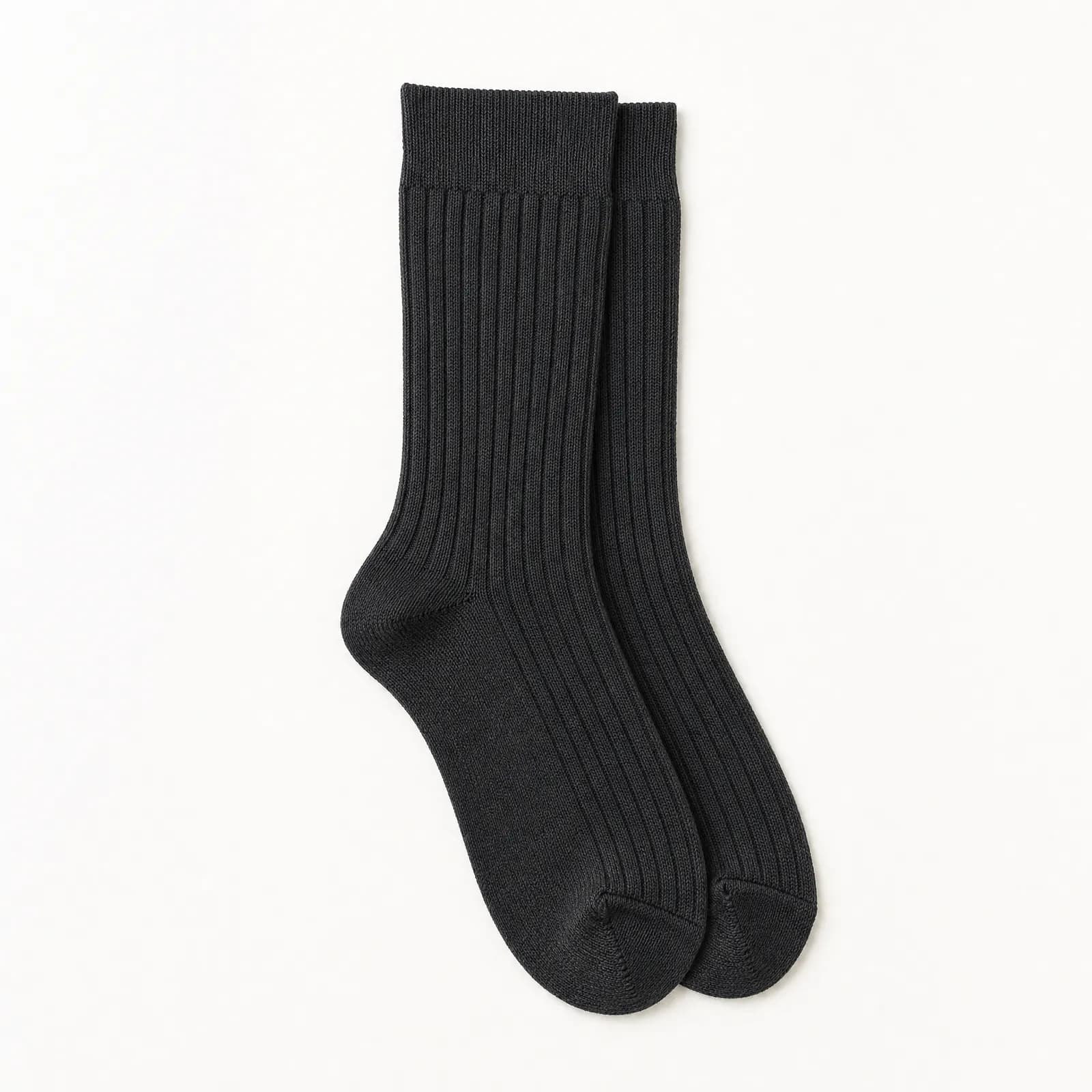 A pair of graphite ribbed socks laid completely flat, one exactly on top of the other, both cuffs relaxed.
